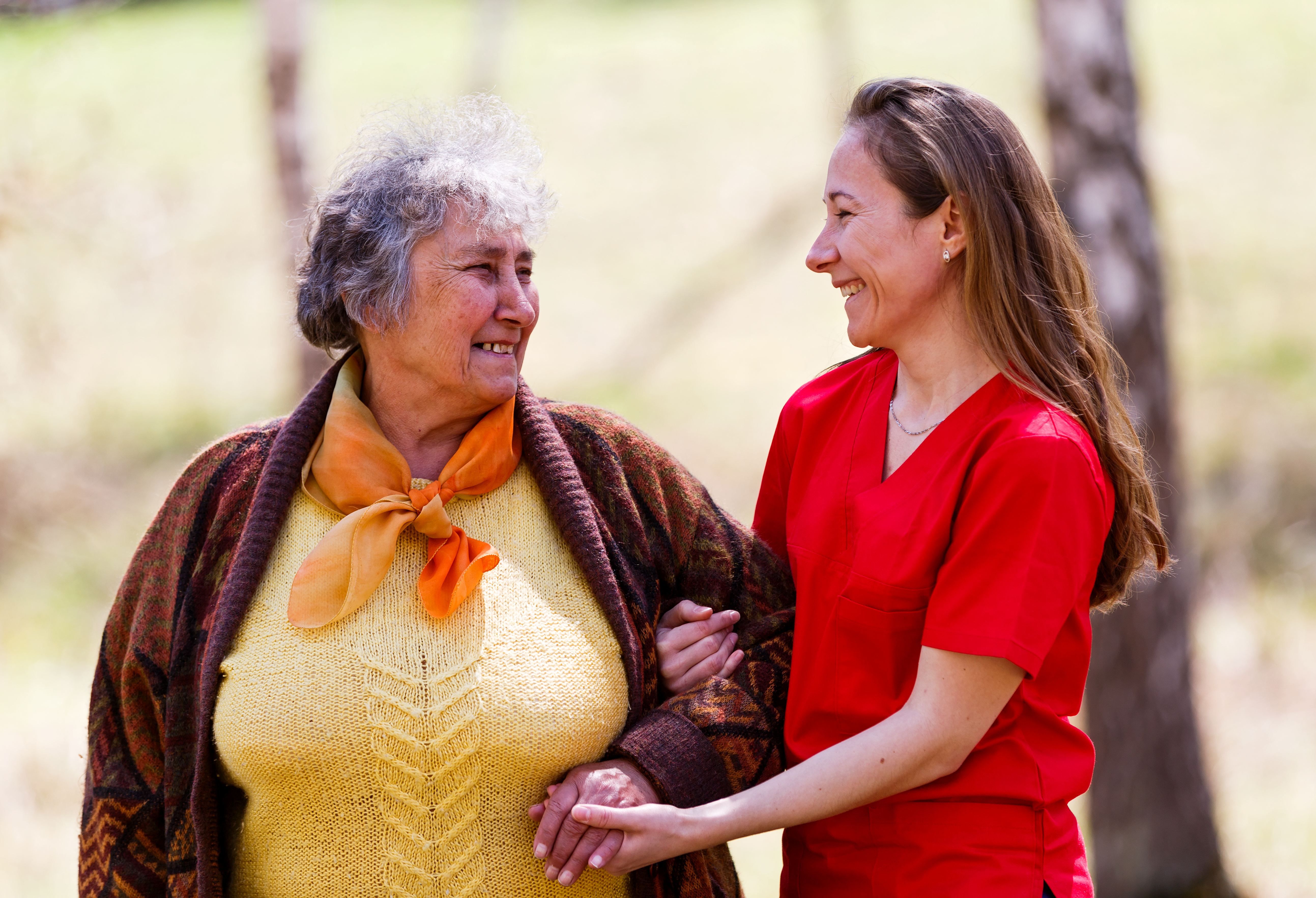 Elderly woman and young caregiver