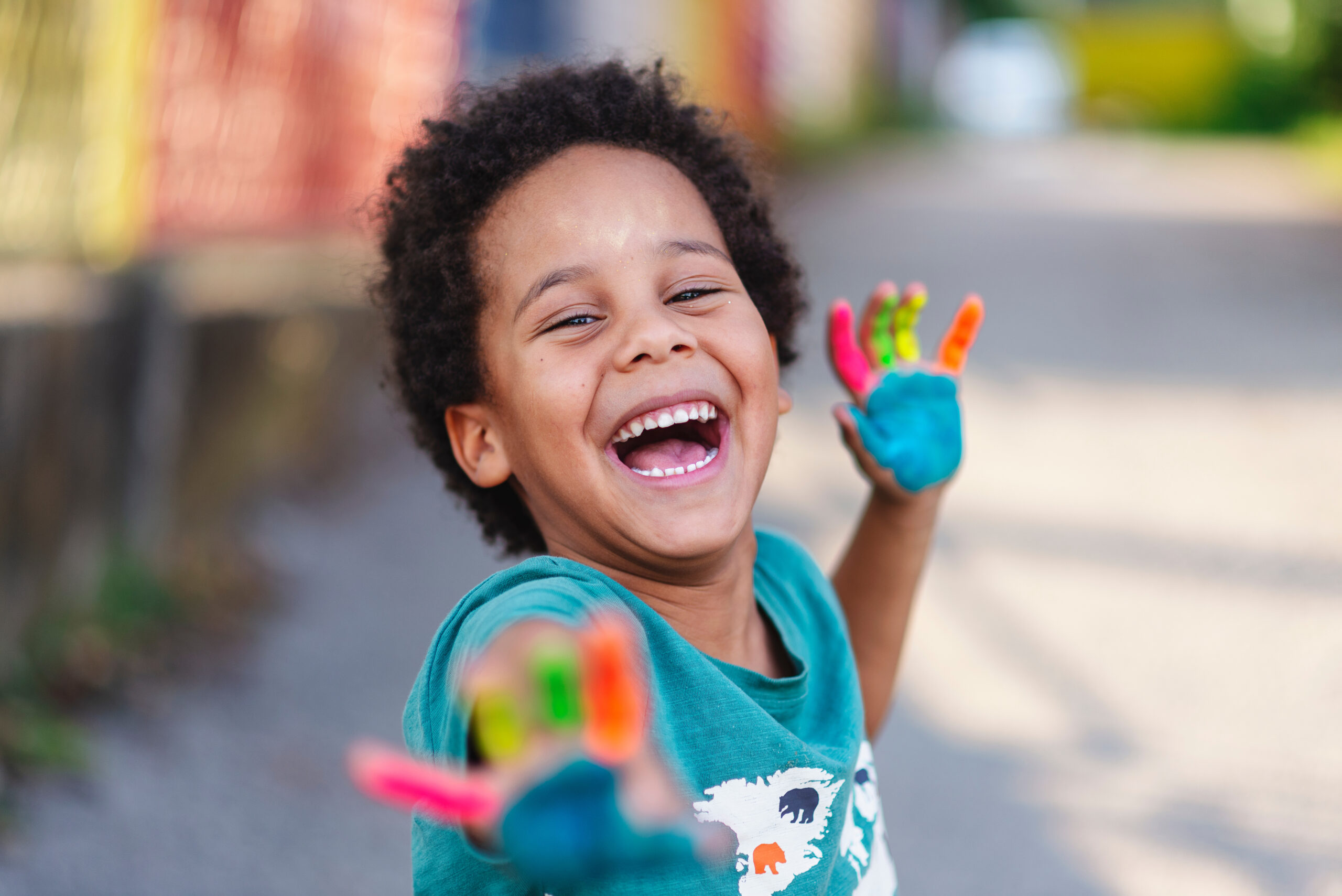 beautiful happy boy with painted hands