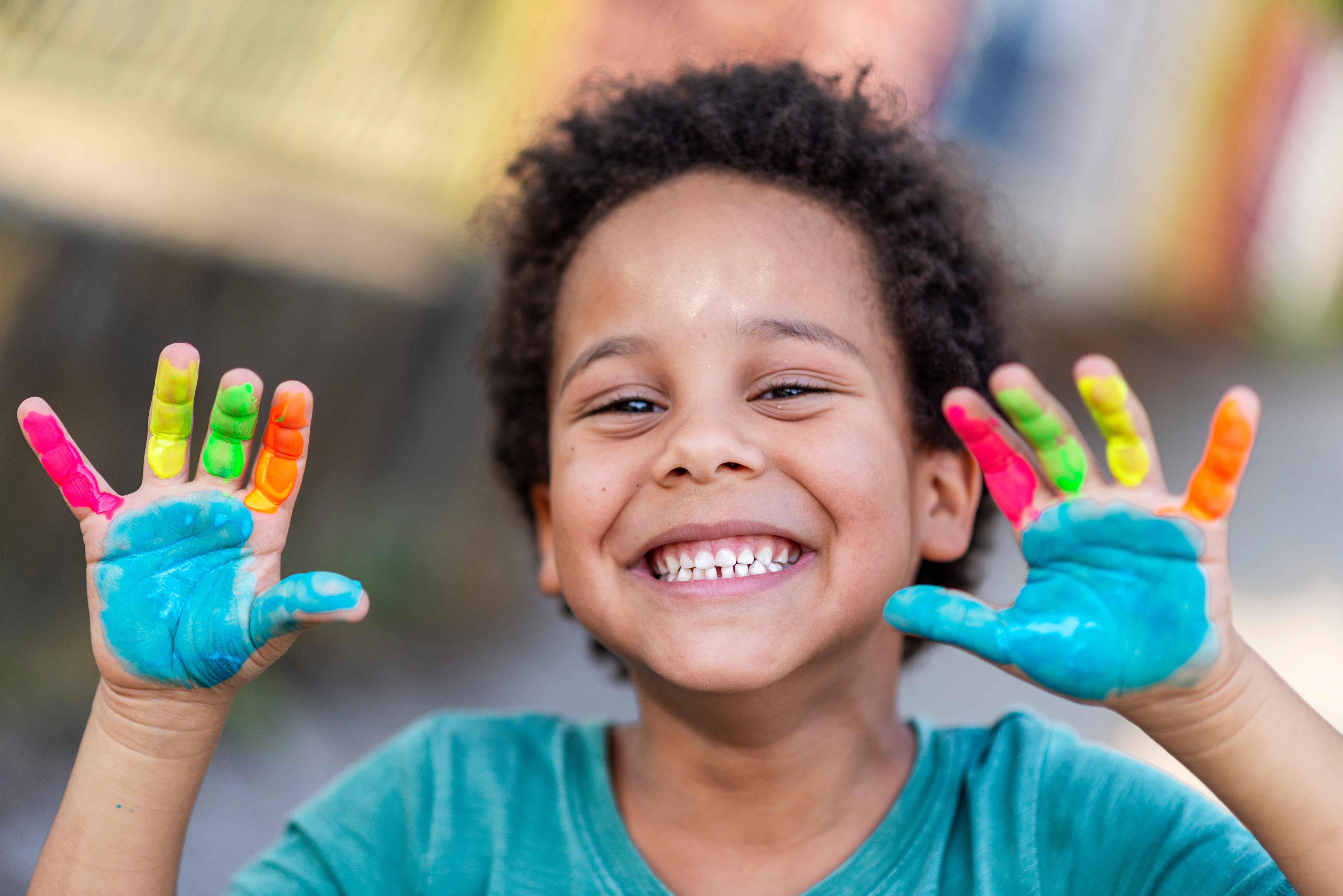 beautiful happy boy with painted hands